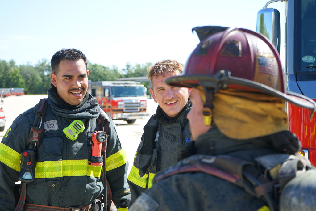 Firefighters at the Osceola County training grounds conversing.