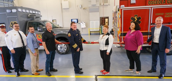 Chairwoman Janer and Fire Chief Larry Collier are joined by others during Tuesday's uncoupling ceremony.