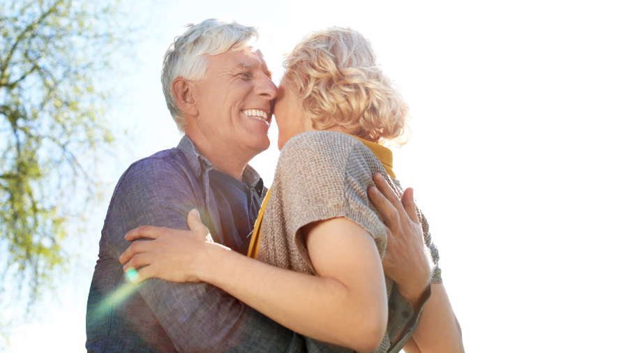 Happy senior couple embraced in a hug