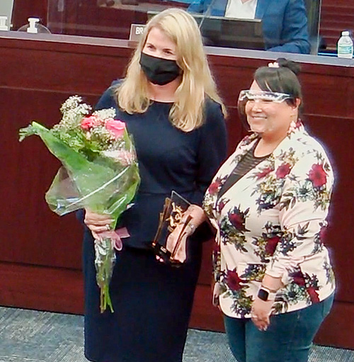 Erika Booth, School librarian at Canoe Creek K-8 presented with Woman Warrior award by Dist 2 Commissioner Janer