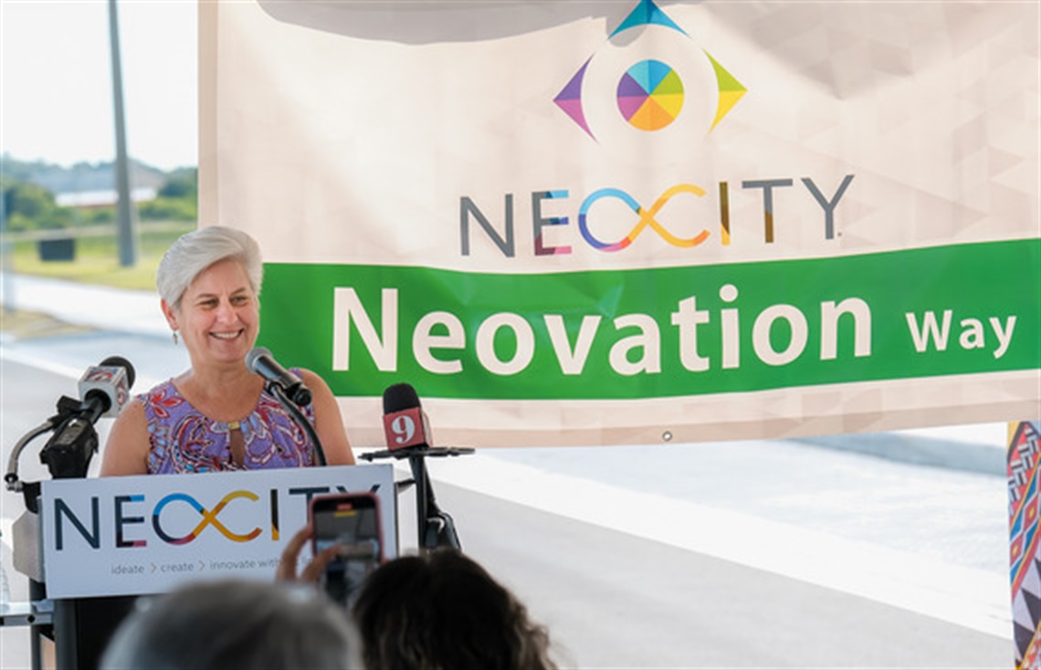 Osceola County Board of County Commissioners Opens Neovation Way with Chairwoman Griebs standing at her podium